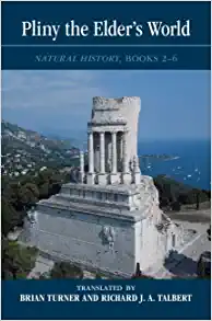 Cover image of book: a ruined white stone monument with some remaining columns on a large rectangular base. The monument sits atop a hill with other hillsides and the ocean visible in the background. In a blue border at the top, the title appears in large white characters: "Pliny the Elder's World: Natural History, Books 2-6." In another blue border at the bottom, white text reads: "Translated by Brian Turner and Richard J.A. Talbert".
