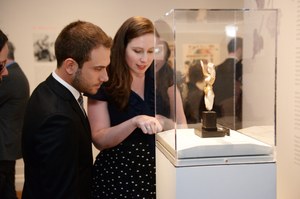 Guests examining a museum object behind a glass case